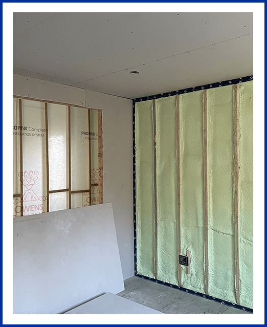 A room with walls being installed and the wall is closed.